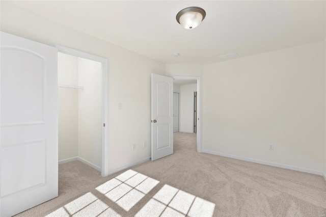 unfurnished bedroom featuring a closet and light colored carpet