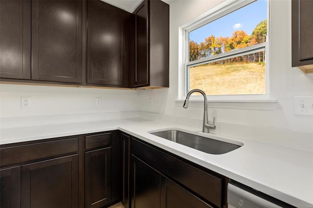 kitchen featuring dark brown cabinetry and sink