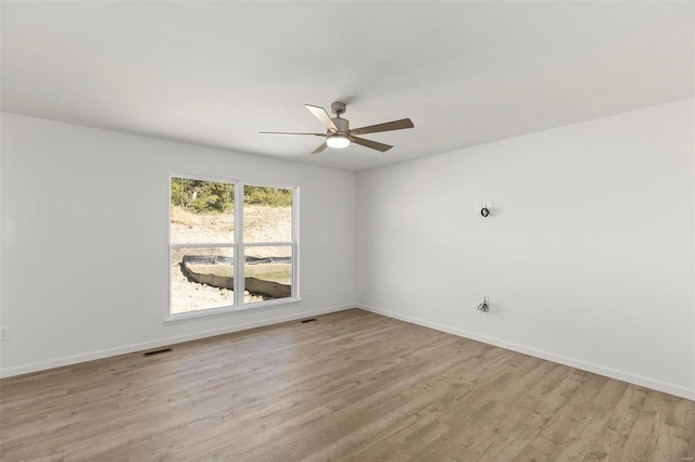 empty room with light hardwood / wood-style floors and ceiling fan