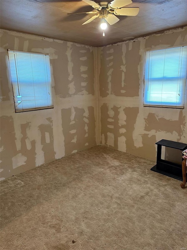 spare room featuring ceiling fan, a textured ceiling, and carpet flooring