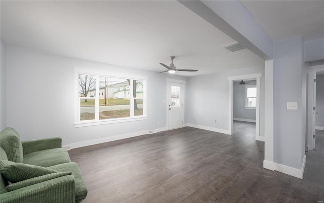 living room featuring ceiling fan and dark hardwood / wood-style flooring