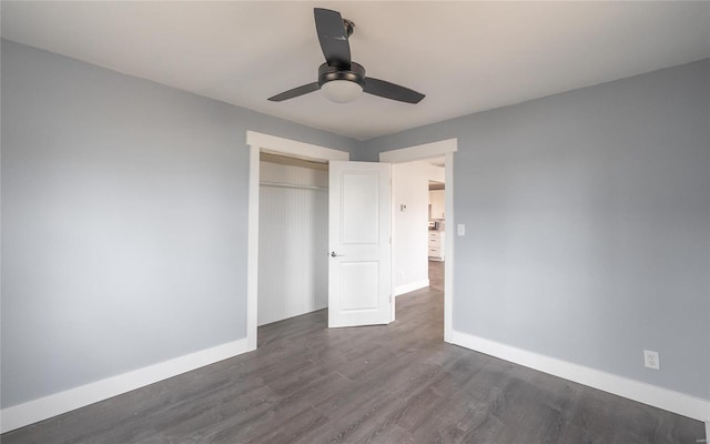 unfurnished bedroom with ceiling fan, a closet, and dark hardwood / wood-style floors