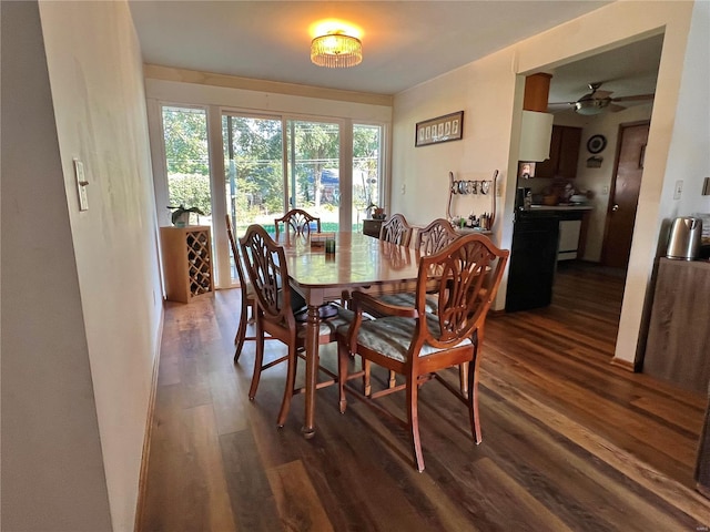 dining space with dark hardwood / wood-style flooring and ceiling fan