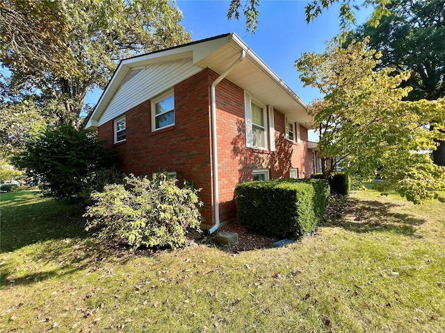 view of side of property with a lawn