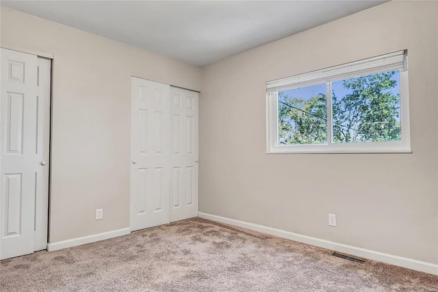 unfurnished bedroom with light colored carpet