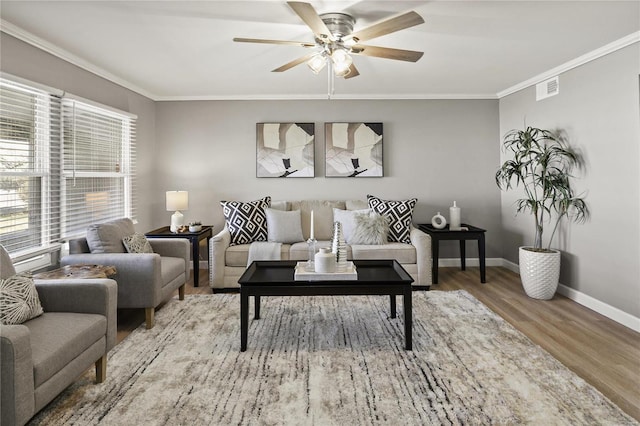 living room featuring ornamental molding, hardwood / wood-style floors, and ceiling fan