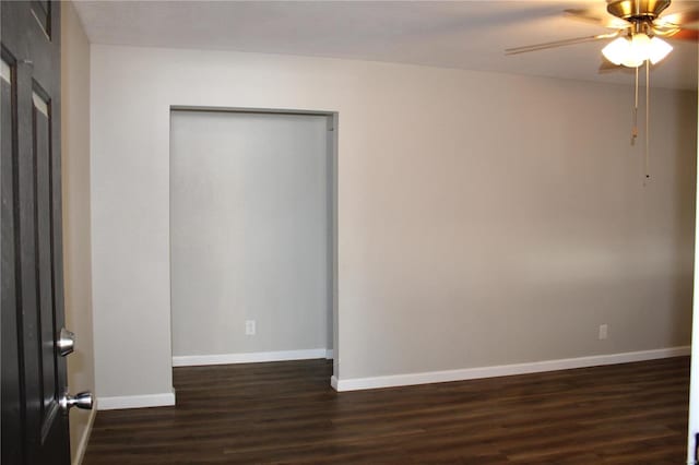 unfurnished room featuring ceiling fan and dark wood-type flooring