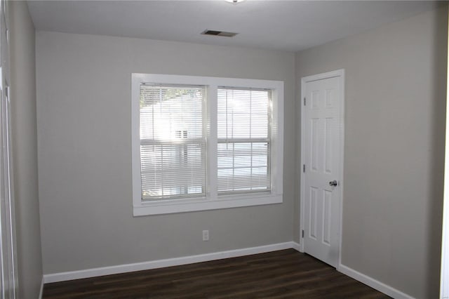 unfurnished room with dark hardwood / wood-style floors