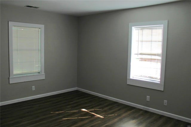 unfurnished room featuring dark wood-type flooring