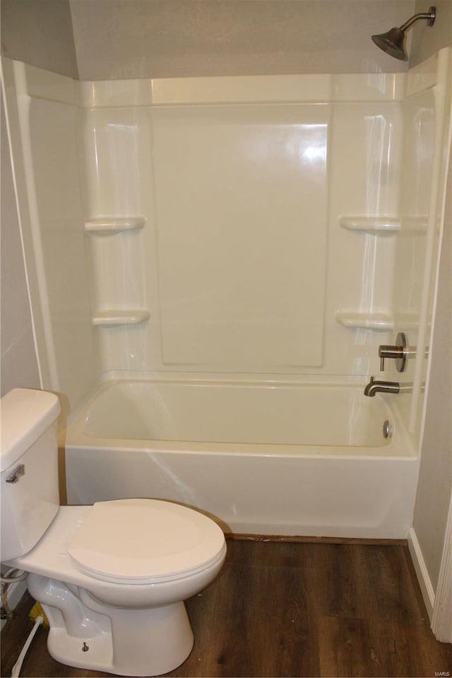 bathroom featuring wood-type flooring, toilet, and  shower combination