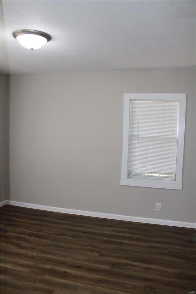 spare room featuring dark wood-type flooring