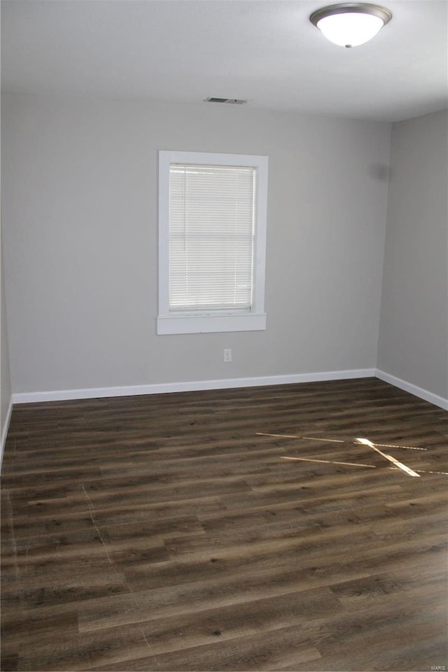 unfurnished room featuring dark hardwood / wood-style floors