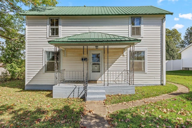 view of front of home with a porch and a front lawn