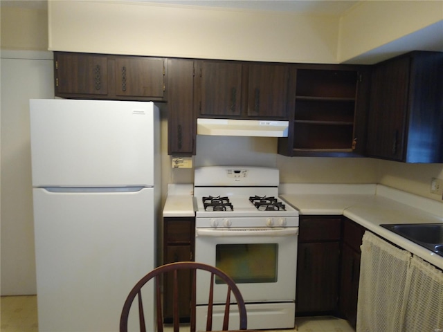 kitchen with dark brown cabinetry and white appliances