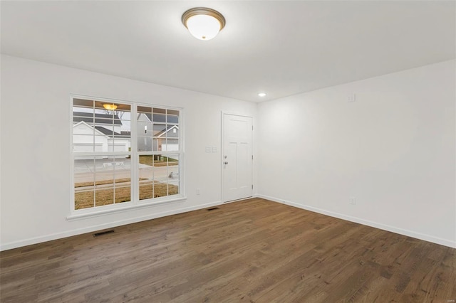 spare room featuring dark hardwood / wood-style floors