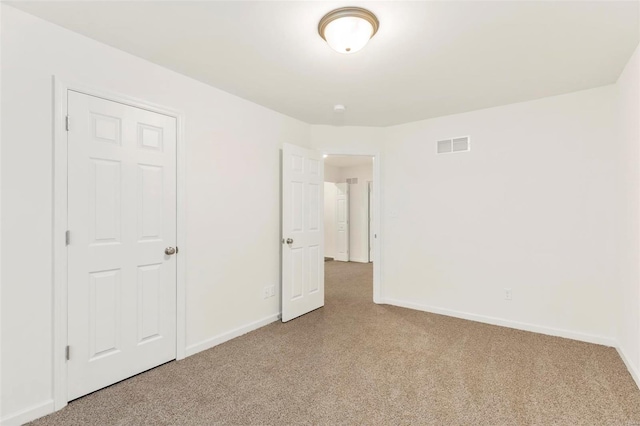 unfurnished bedroom with a closet and carpet flooring