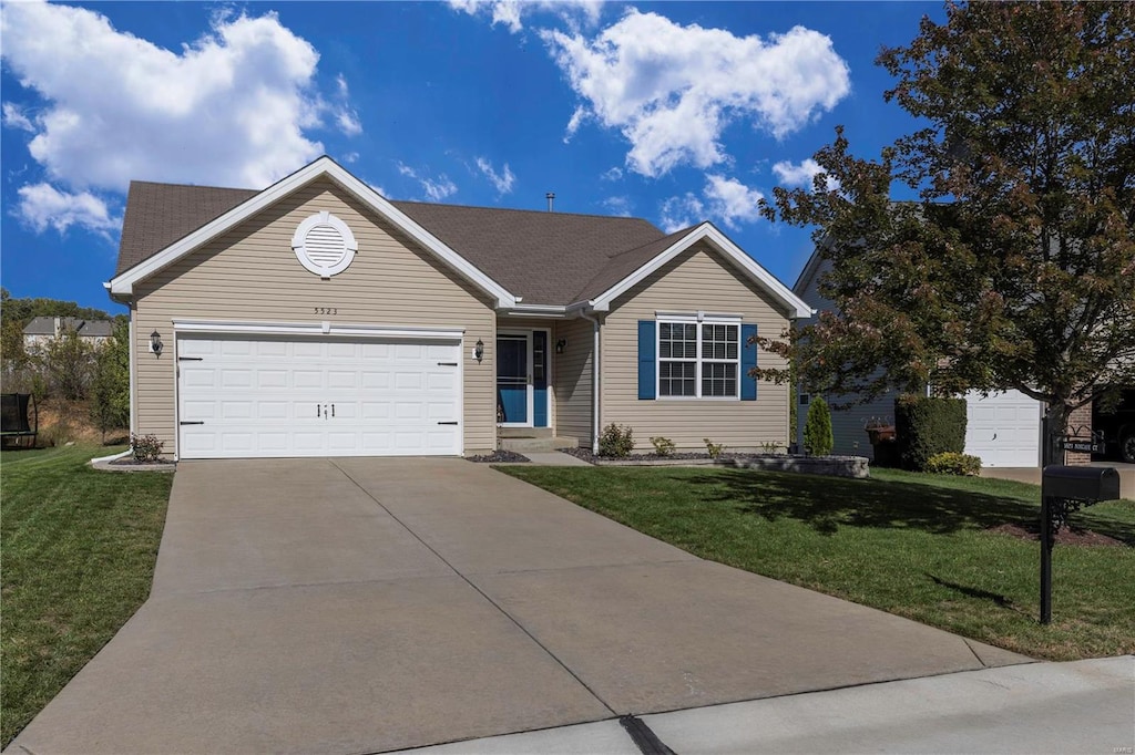 ranch-style house featuring a front lawn and a garage