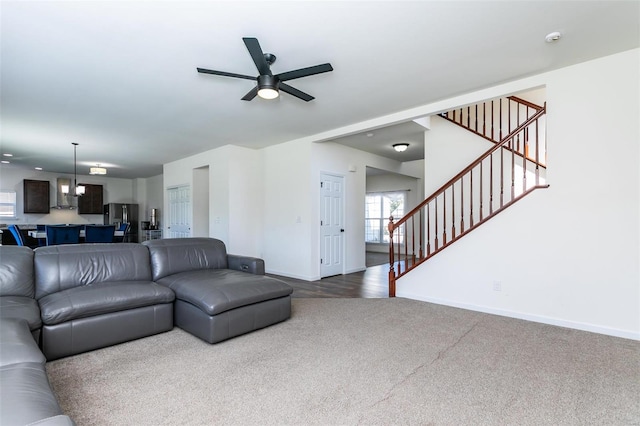 living room featuring wood-type flooring and ceiling fan