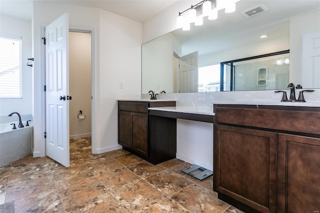 bathroom with vanity and separate shower and tub