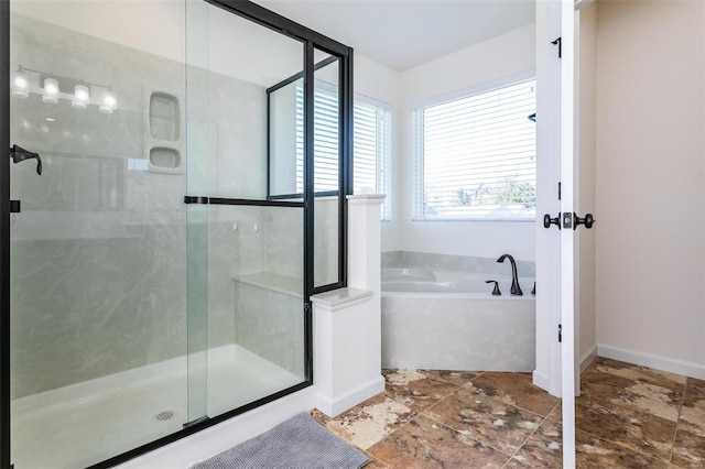 bathroom featuring independent shower and bath