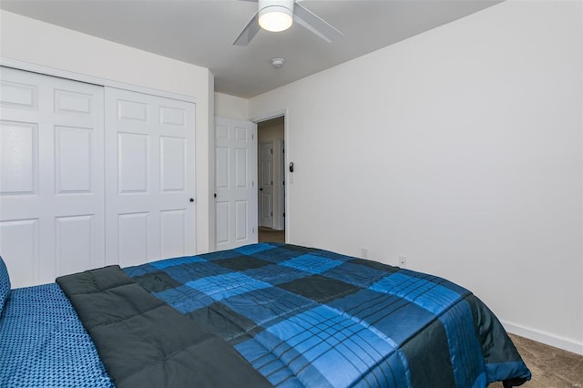 carpeted bedroom featuring a closet and ceiling fan