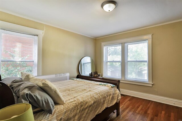 bedroom featuring ornamental molding and dark hardwood / wood-style floors