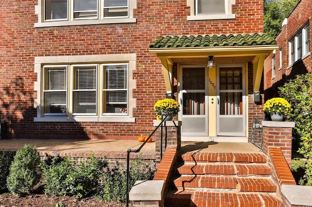 property entrance featuring brick siding