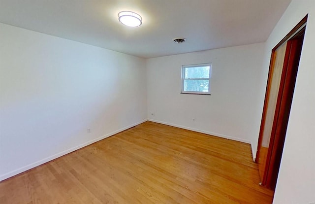 unfurnished room with light hardwood / wood-style flooring