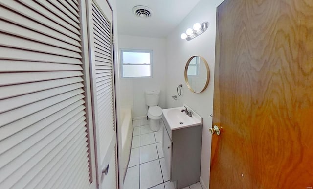 bathroom featuring tile patterned floors, vanity, and toilet