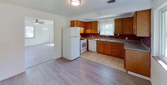 kitchen featuring ceiling fan, white appliances, sink, and light hardwood / wood-style floors