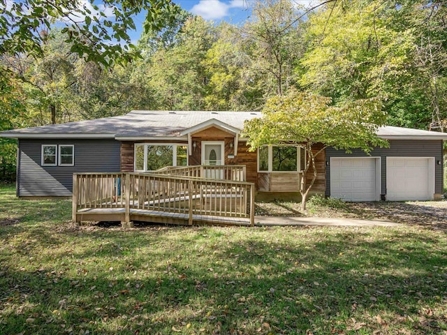 view of front facade with a garage, a deck, and a front lawn