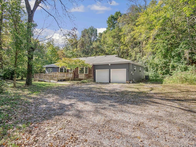 ranch-style house featuring a garage and a deck