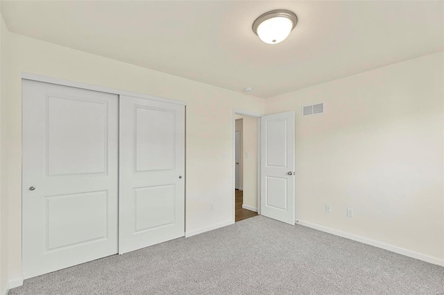 unfurnished bedroom with carpet floors and a closet