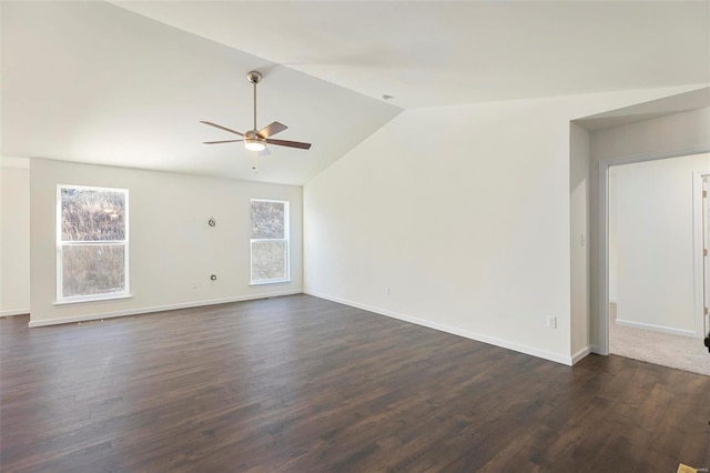 unfurnished room with lofted ceiling, a healthy amount of sunlight, ceiling fan, and dark wood-type flooring