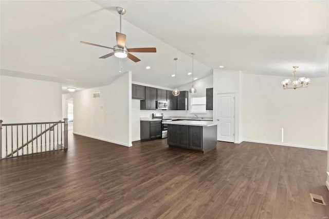 kitchen featuring dark brown cabinets, stainless steel appliances, dark hardwood / wood-style floors, lofted ceiling, and a center island