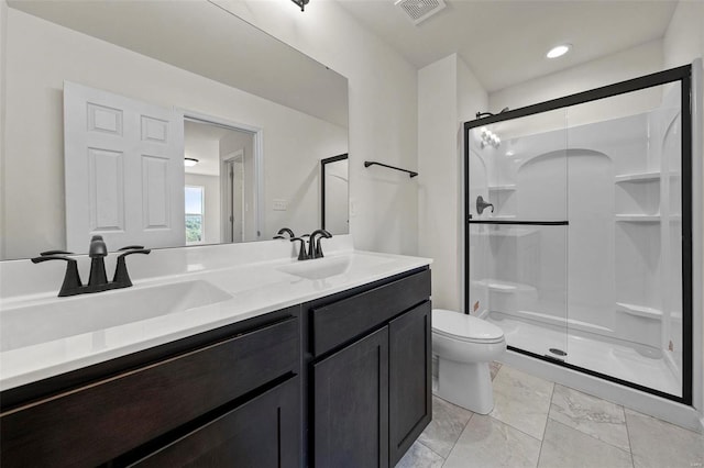 bathroom with an enclosed shower, vanity, and toilet