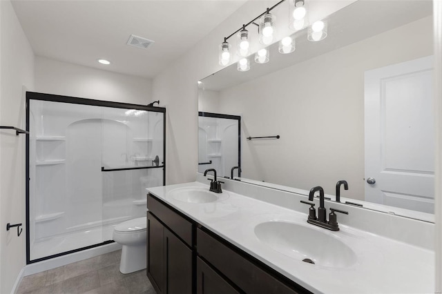 bathroom featuring walk in shower, vanity, and toilet