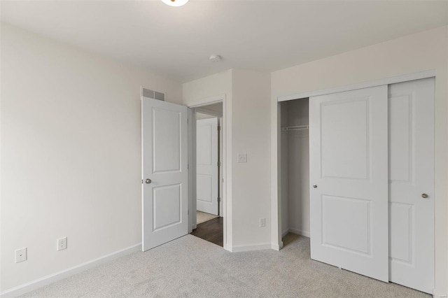 unfurnished bedroom featuring carpet floors and a closet