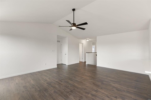 empty room featuring ceiling fan, vaulted ceiling, and dark hardwood / wood-style flooring