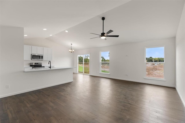 unfurnished living room featuring ceiling fan with notable chandelier, dark hardwood / wood-style floors, vaulted ceiling, and sink