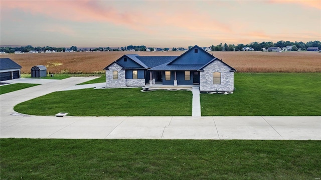 craftsman-style house with a yard and a storage shed