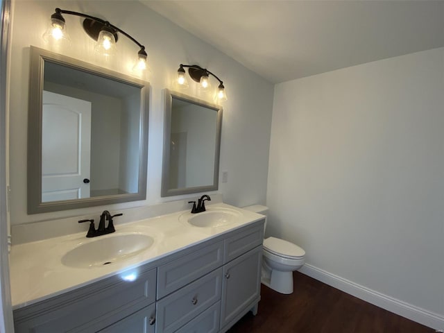 bathroom featuring hardwood / wood-style flooring, vanity, and toilet