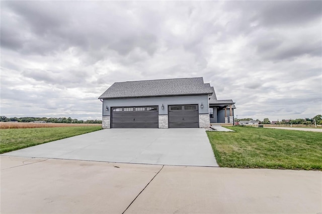 view of front of property with a front yard and a garage