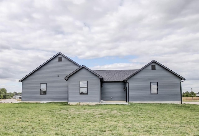 rear view of house with a yard