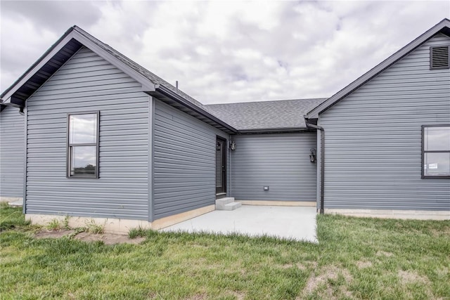 rear view of property featuring a yard