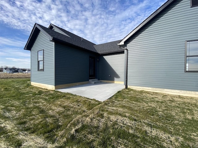 rear view of house featuring a patio and a lawn