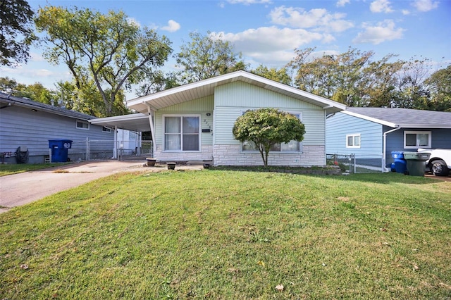 view of front of home with a front yard and a carport