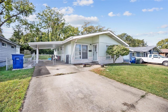 view of front of home with a front lawn and a carport