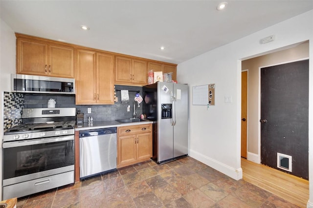 kitchen featuring backsplash, dark hardwood / wood-style floors, appliances with stainless steel finishes, and sink