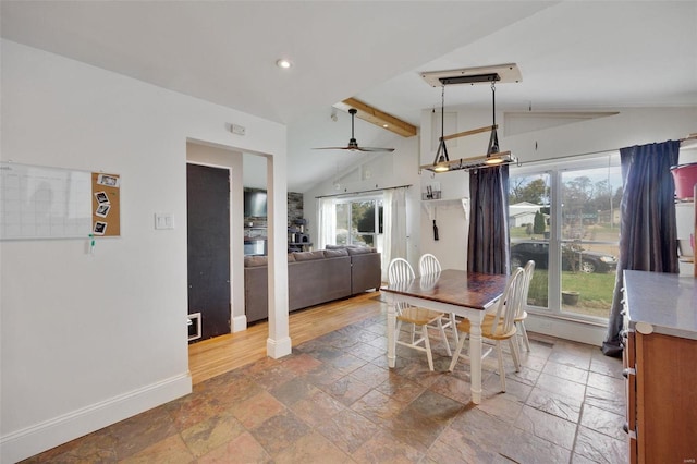 dining space featuring lofted ceiling with beams and ceiling fan